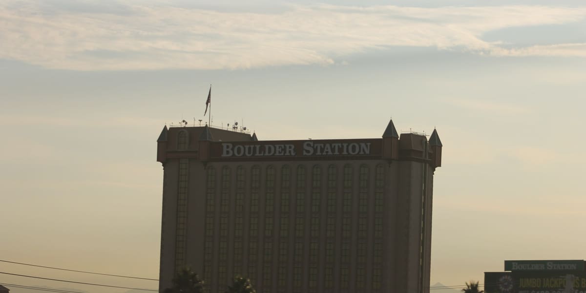 Boulder Station hotel tower with corner turrets and its name across the top in hazy morning light