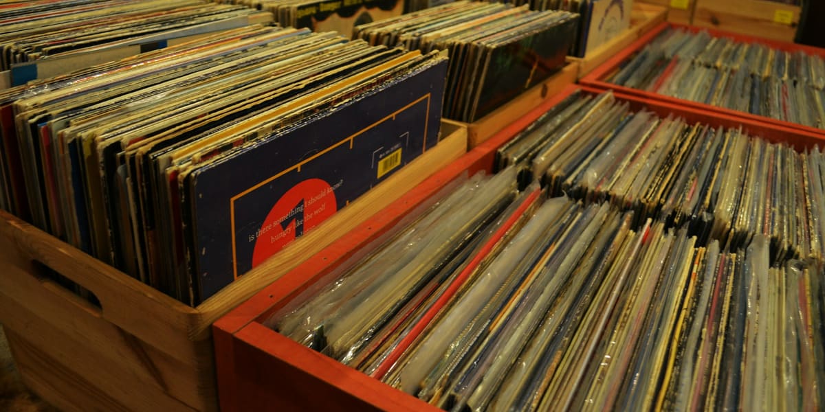 Wooden crates packed with used vinyl records in a record store
