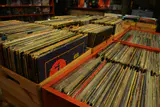 Wooden crates packed with used vinyl records in a record store