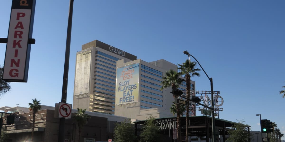 Downtown Grand hotel tower and its street-level entrance on a clear evening