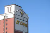 Top of the El Cortez hotel tower with its gold script logo against a blue sky