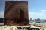 The curved bronze Encore tower with its signature script logo, seen from a high vantage point