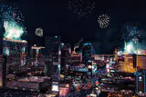 Fireworks bursting above Las Vegas Strip hotel towers at night, seen from above