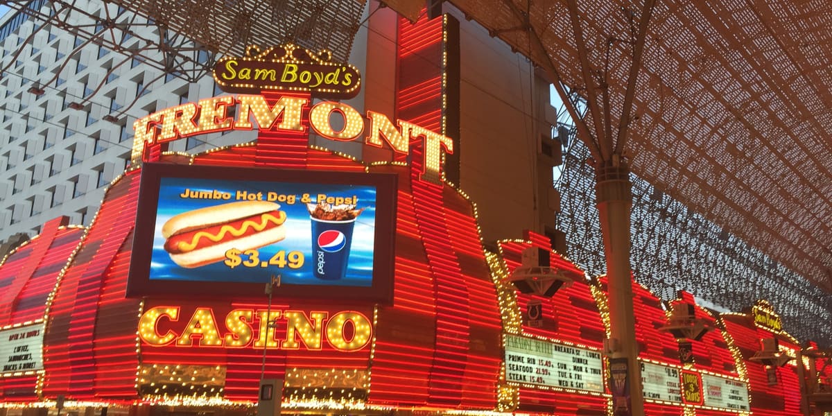 Red and gold neon facade and Fremont Casino sign under the Fremont Street Experience canopy