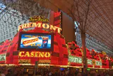 Red and gold neon facade and Fremont Casino sign under the Fremont Street Experience canopy