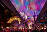Crowds beneath the illuminated LED canopy of the Fremont Street Experience in downtown Las Vegas at night