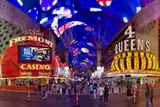 Neon casino hotel facades under the lit canopy of the Fremont Street Experience in downtown Las Vegas
