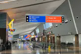 Concourse at Harry Reid International Airport with overhead signs for gates, baggage claim and ground transportation