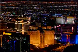Las Vegas Strip resorts lit up at night, seen from a helicopter above Paris Las Vegas