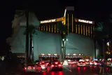 The Luxor sphinx beside Las Vegas Boulevard at night, with the gold Mandalay Bay hotel tower behind