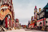 Rows of retired vintage casino and hotel signs lining a gravel path in an outdoor boneyard