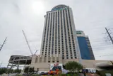 Palms hotel tower under an overcast sky with construction cranes beside it