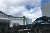 Park MGM hotel tower and entrance canopy with Park MGM signage under a cloudy sky