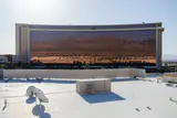 The long low-rise Red Rock Resort hotel tower with reflective windows, seen across a flat rooftop