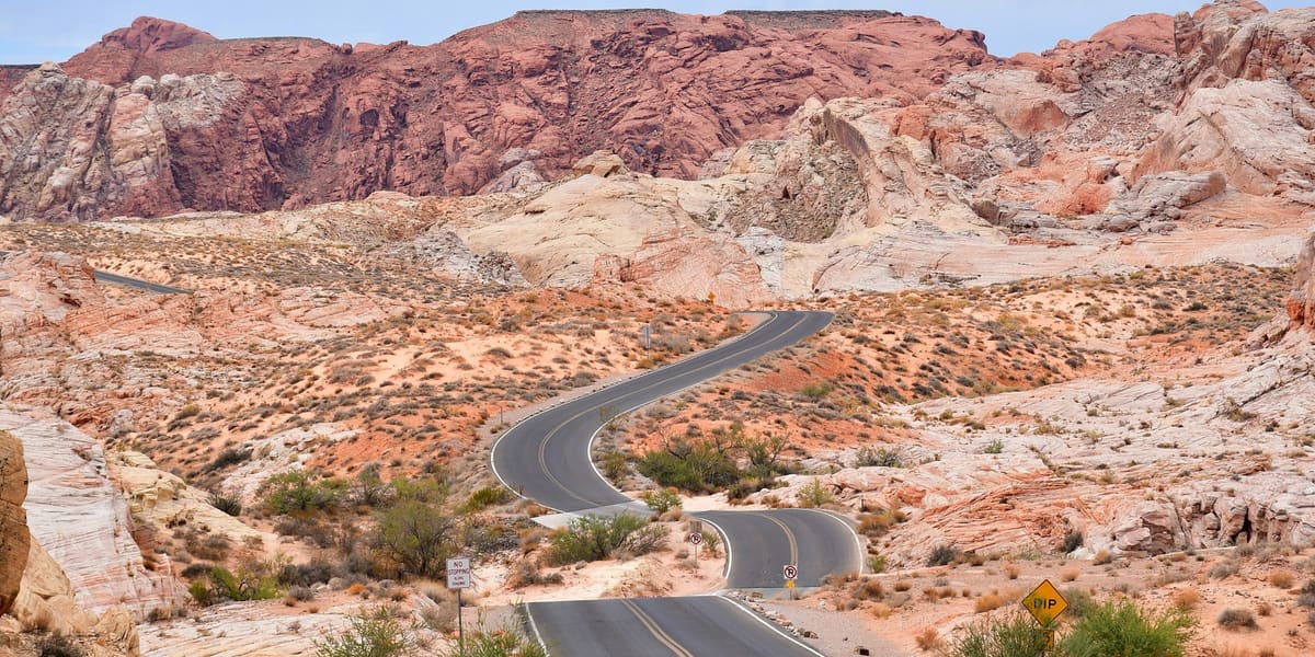 A winding park road through red and white sandstone formations in Valley of Fire State Park
