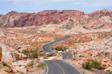 A winding park road through red and white sandstone formations in Valley of Fire State Park